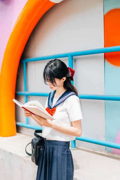 istock A girl reading in the park 1459065510