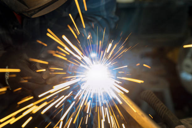 istock Using a semiautomatic argon gas shielded welding machine, a worker works welding a metal with sparkle using a welding machine that is semi-automatic 1459065517