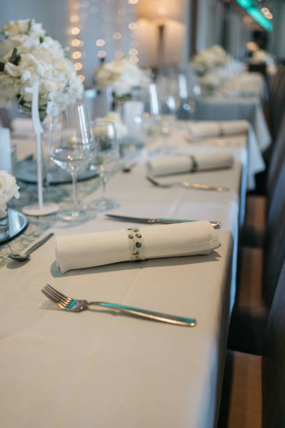 istock long set wedding table with rolled napkins and wine glasses 1459065602