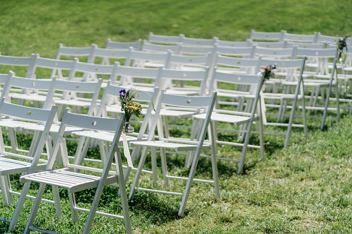 Folding chairs at a free wedding ceremony outdoor with wedding decorations