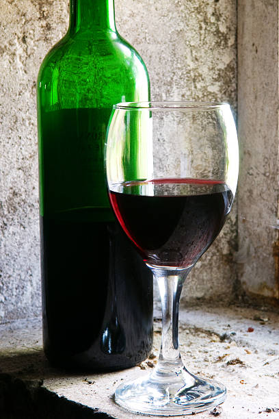 Bottle and glass of red wine stock photo