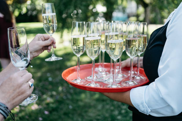 istock waitress is serving champagne on a red tray 1459066079