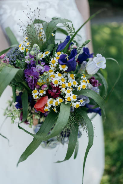 istock bride holds wedding bouquet with meadow flowers with spring colors 1459066131