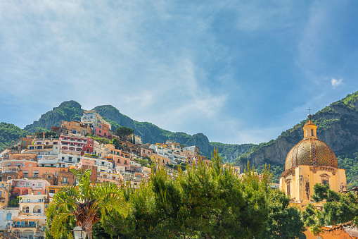 Positano town with colorful buildings and church of Our Lady of the Assumption on Amalfi coast, Campania, Italy. Popular summer resort