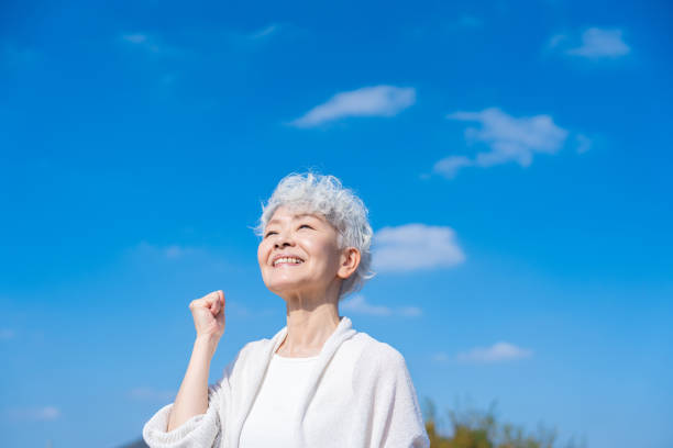 istock Senior woman posing with guts under the blue sky 1459066562