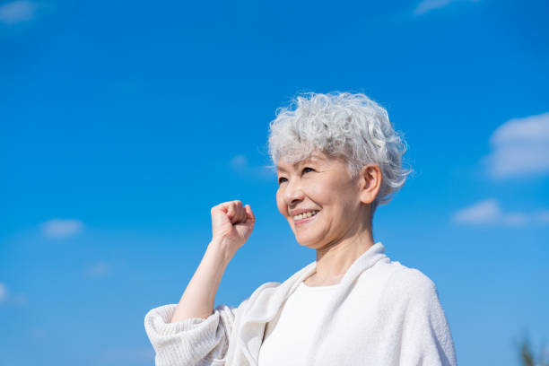 istock Senior woman posing with guts under the blue sky 1459066570