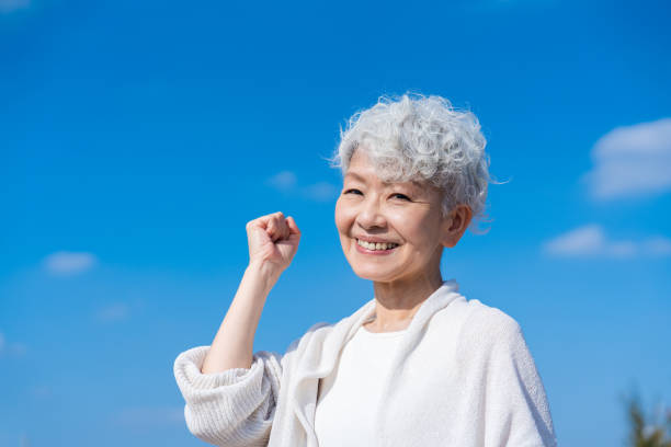 istock Senior woman posing with guts under the blue sky 1459066573