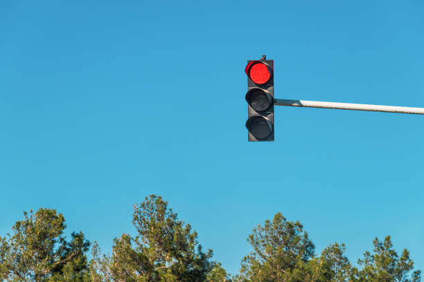 istock Modern traffic light with red light in front of cloudless sunny blue sky 1459066721