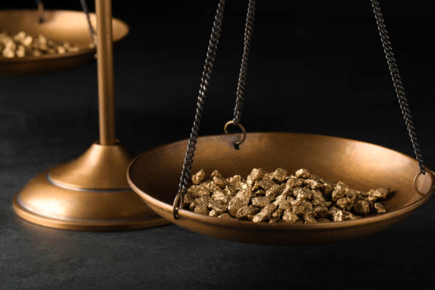 istock Vintage scales with gold nuggets on dark table, closeup 1459066744