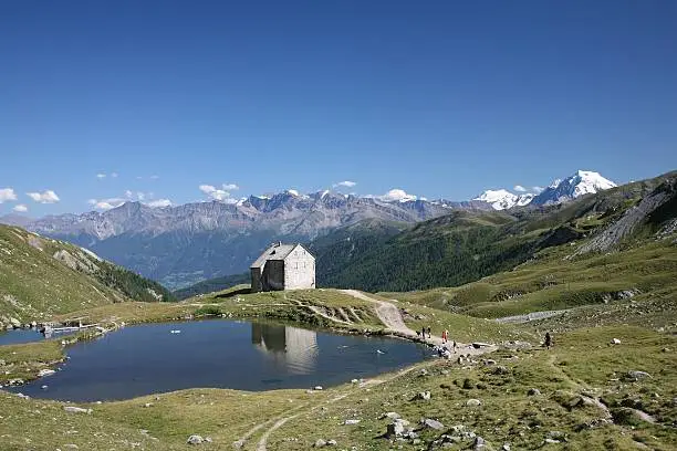 Abandoned Pforzheim lodge in the Valle Slingia, Italy. The rightmost peak in the background is the Ortler, the highest peak in South Tyrol.
