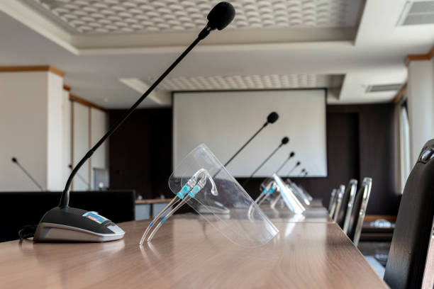 istock Brown chair and tabler row with microphone on table in meeting room 1459069574
