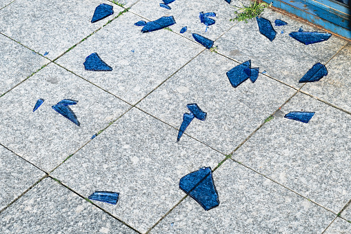 Broken blue glass on ground