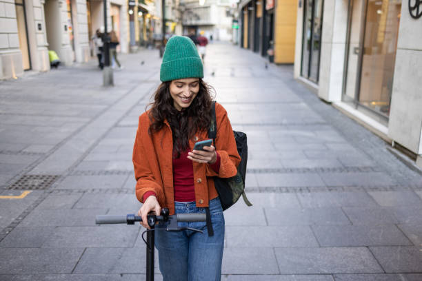 istock Smiling young woman communicating on her smart phone 1459073969