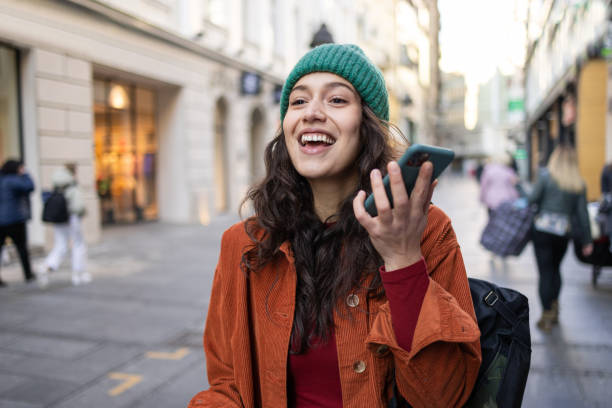 istock Smiling young woman communicating on her smart phone 1459073970