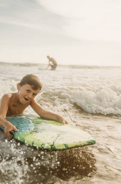 istock Boys having fun with bodyboards in Acapulco 1459076726