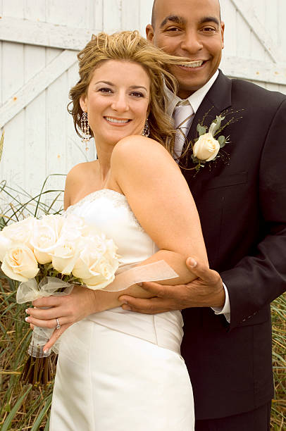 Bride and groom looking and smiling at camera.
