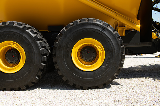 A dumper truck wheel in a quarry in summertime