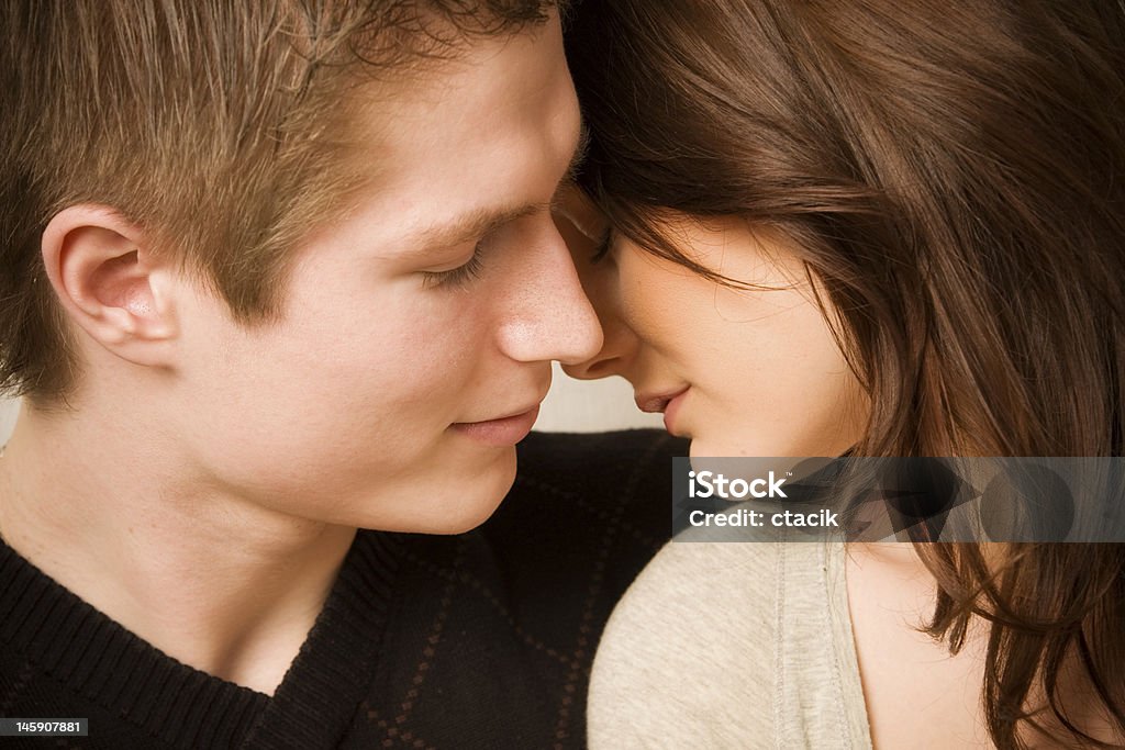 A young loving couple about to kiss young couple in love, face to face Activity Stock Photo