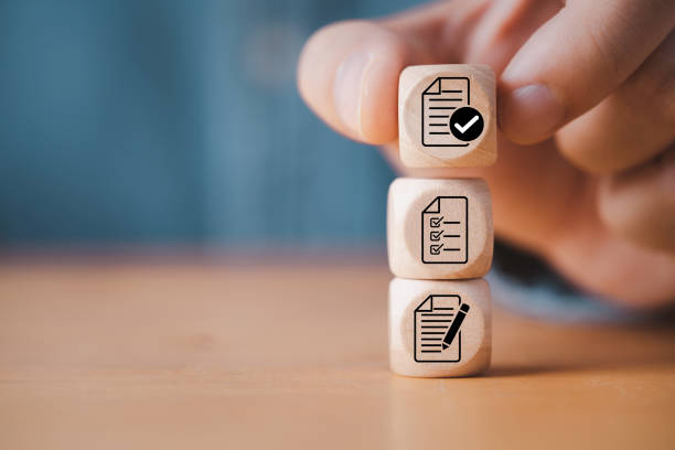 istock Hand stacking document which print screen on wooden cube block for prepare check and approve document , Quality assurance and ISO guarantee concept. 1459081730