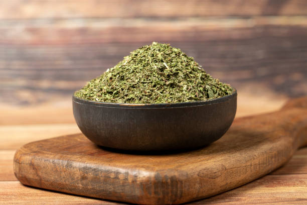 istock Dried mint spice. Dried mint leaves in bowl on rustic table. Dry spice concept 1459081956