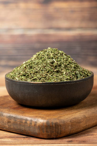 istock Dried mint spice. Dried mint leaves in bowl on rustic table. Dry spice concept 1459081995