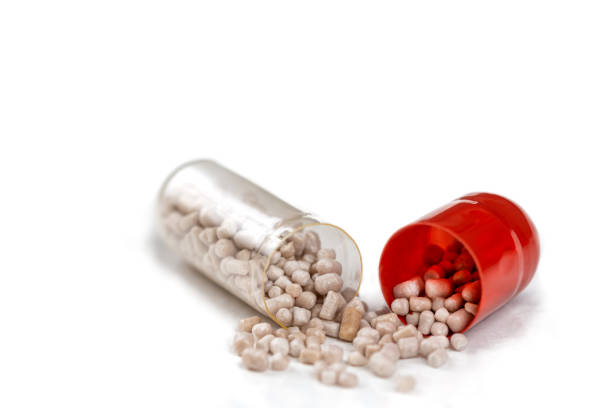 Capsule separated in half in macro on a white background.
