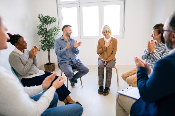 istock Multiracial people applauding during support group psychotherapy 1459084301