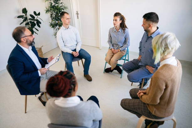 istock Woman sharing her emotions during group therapy 1459084874