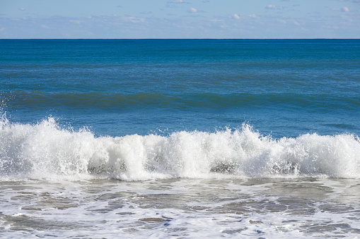 Striking scene of waves breaking on the sand of a Spanish beach