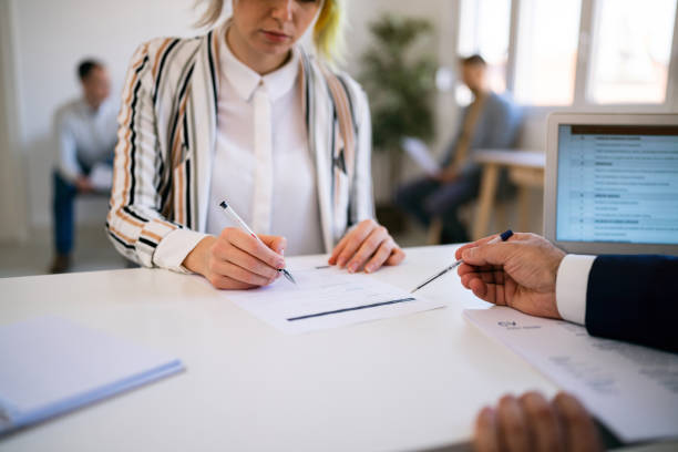 istock Female candidate, fills in an application form while having a job interview with a recruiter 1459087724