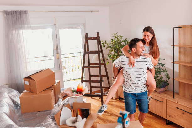 istock Husband piggybacking wife while moving in new home 1459092801