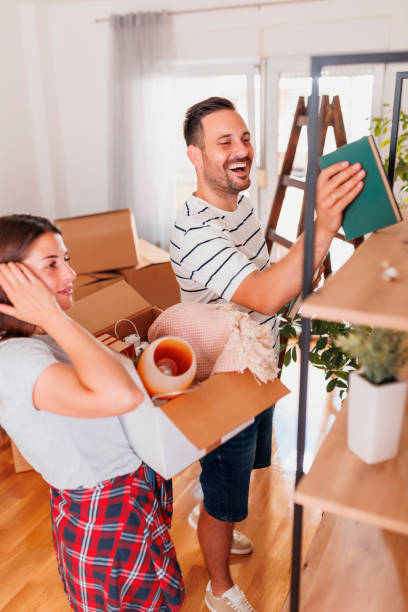 istock Couple moving in new house unpacking things 1459092931