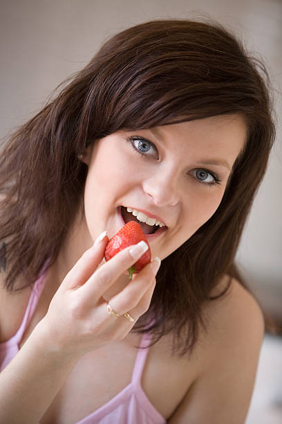 istock Woman eating strawberries 145909433