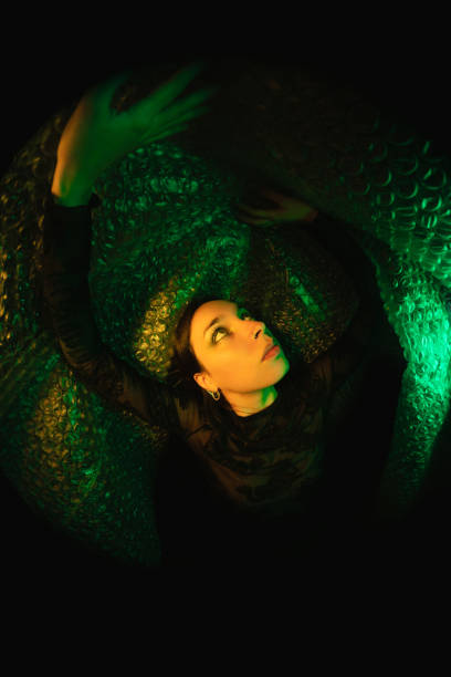 Woman portrait illuminated neon light trapped concept