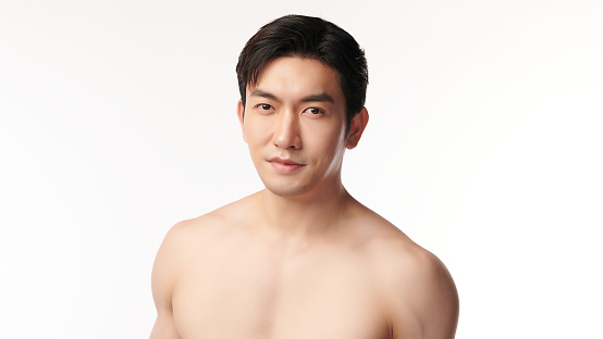 Portrait of shirtless young handsome Asian man for skincare and beauty concepts against on white background,