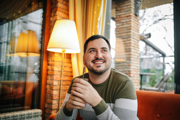 istock Man sitting in the bar and drinking his morning coffee 1459095495