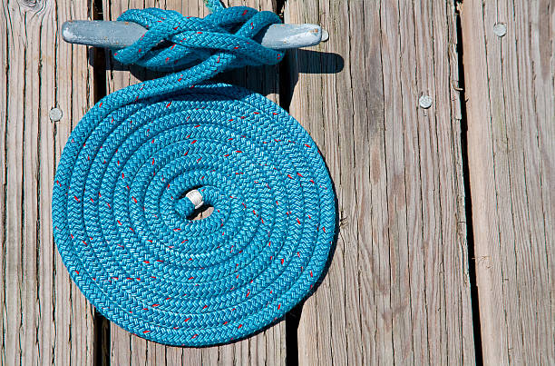 A Coil of Blue Nautical Rope on a Wooden Pier