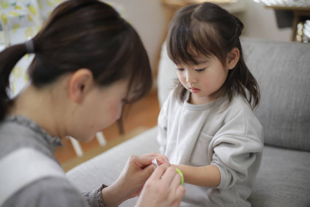 istock mother cutting child's nails 1459098140