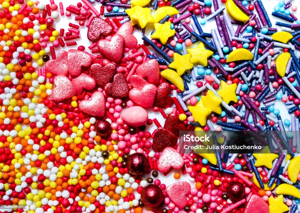 Background with a lot of delicious decorations in the form of colorful beads. Confectionery. Sweets Background with a lot of delicious decorations in the form of colorful beads. Confectionery. Sweets. Beauty Stock Photo