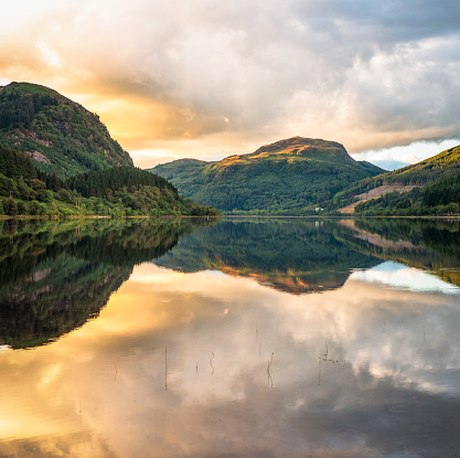 The waters of Loch Lubnaig in Scotland's Trossachs region, calm at sunset in September.
