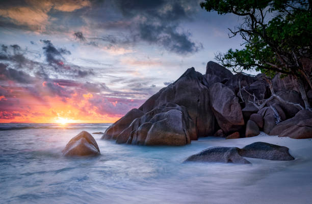 istock Beautiful sunset on the beach with typical granite rock formations on Praslin island , Granitic Seychelles , archipelago country in the Indian Ocean 1459105277