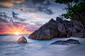 Beautiful sunset on the beach with typical granite rock formations on Praslin island , Granitic Seychelles , archipelago country in the Indian Ocean