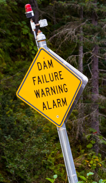 istock Tilted DAM FAILURE WARNING ALARM sign in Valdez, Alaska 1459106426