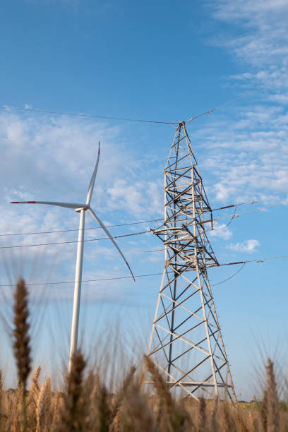 istock Windmill generates clean energy for power transmission lines 1459116834