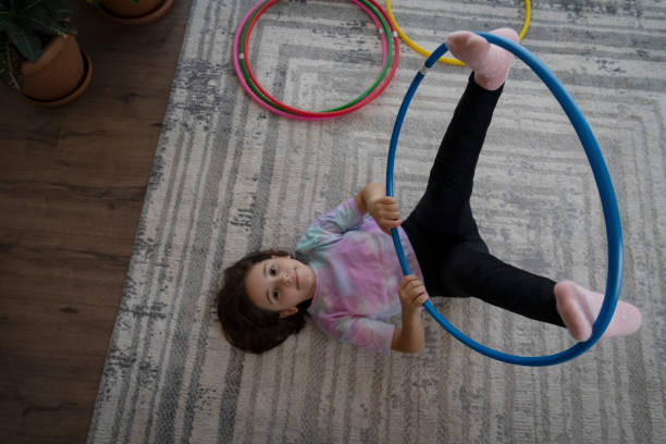 istock Little girl playing with hula hoop 1459118254