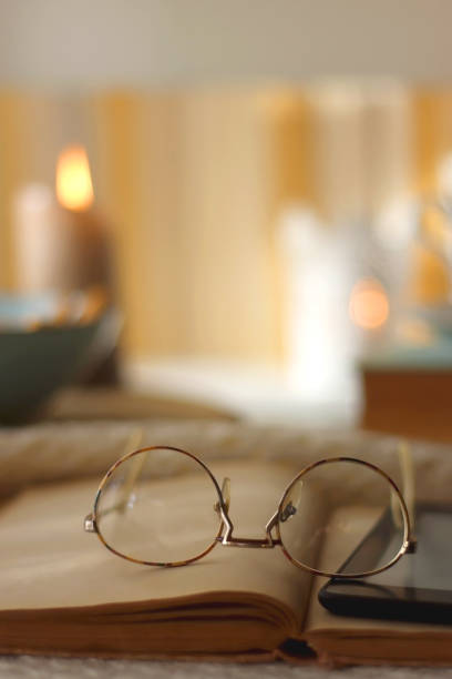 istock Books, Glasses, E-Reader, Cookies, Tea and Candle 1459118678