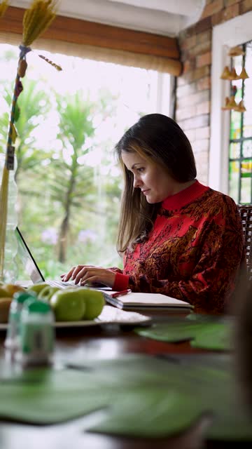 Woman works from home with her laptop
