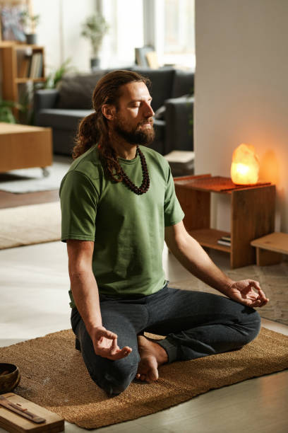 istock Man doing yoga at home 1459121228