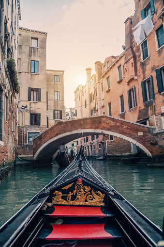 Gondola ride on a canal of Venice in Italy, view from the gondola