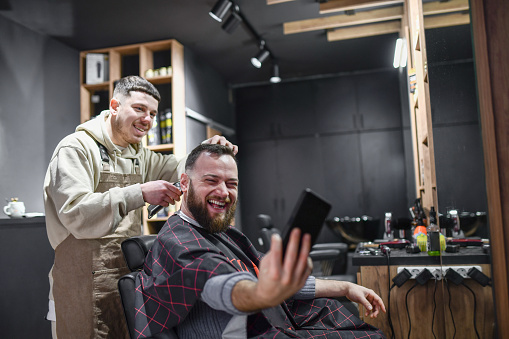 Customer Taking Selfie With Barber While Getting A Haircut